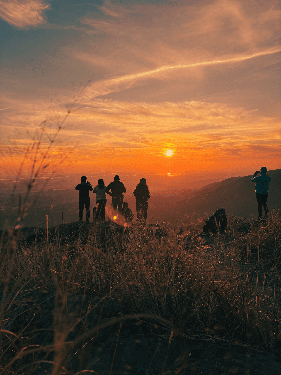 Community members enjoying a beautiful sunset together in nature